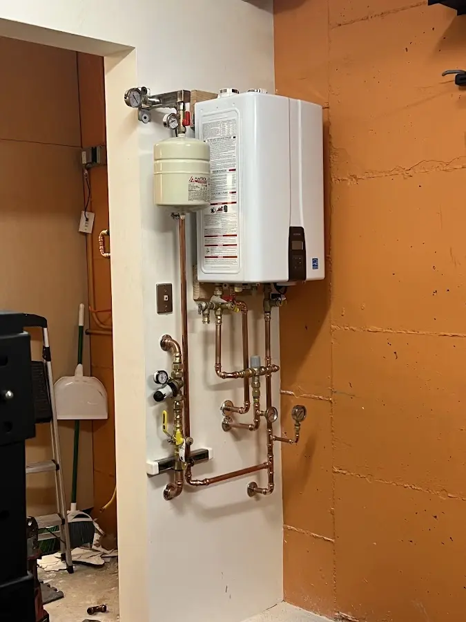 Plumbing technician inspecting water heater connections in Saratoga